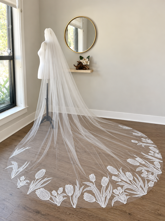 Tulip embroidered cathedral wedding veil displayed from the side in Haus of Lace studio setting