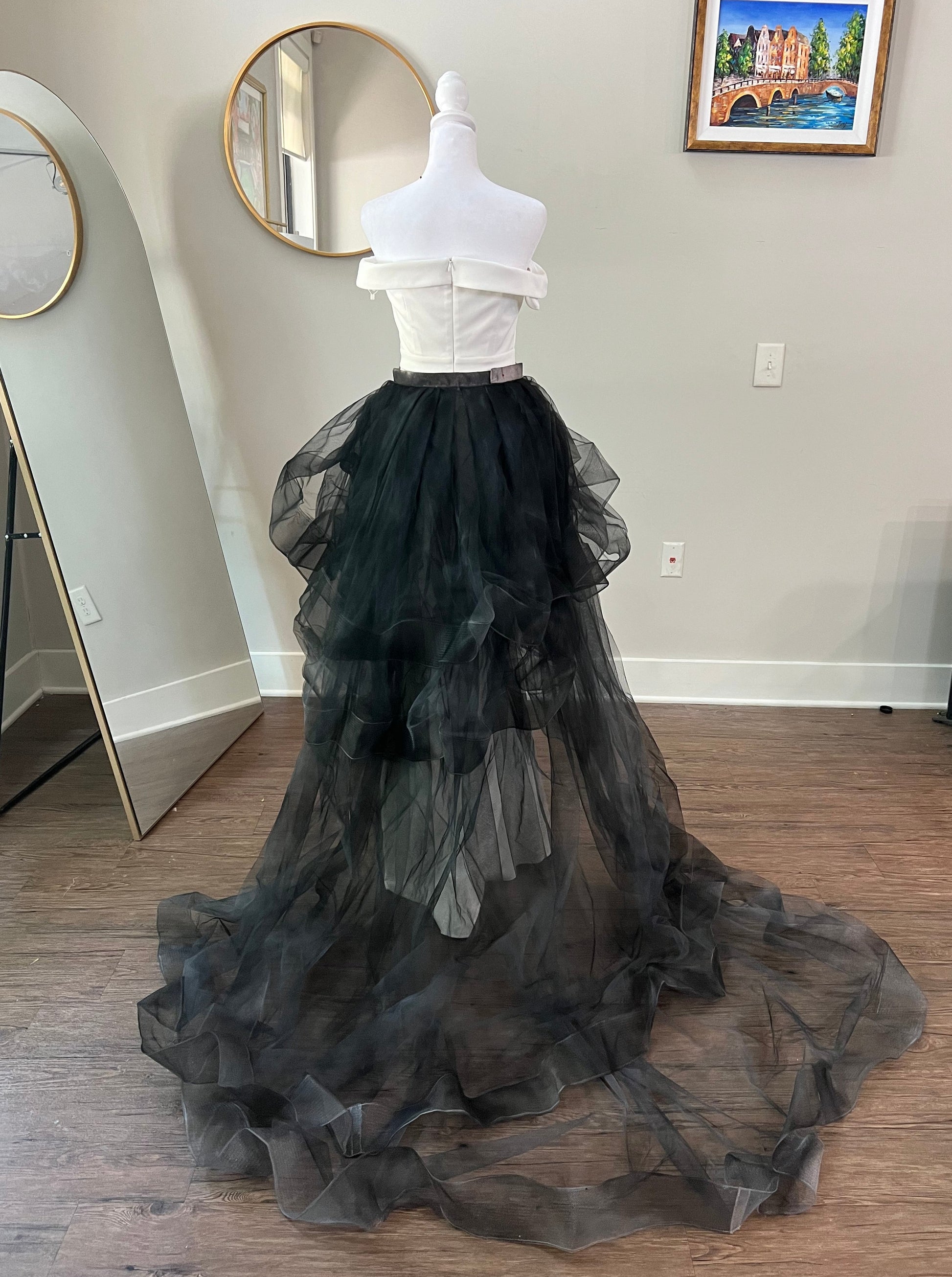 elegant black wedding train cascading gracefully, featuring detailed lace and tulle fabric, perfect for a dramatic and sophisticated look at a gothic-themed wedding."