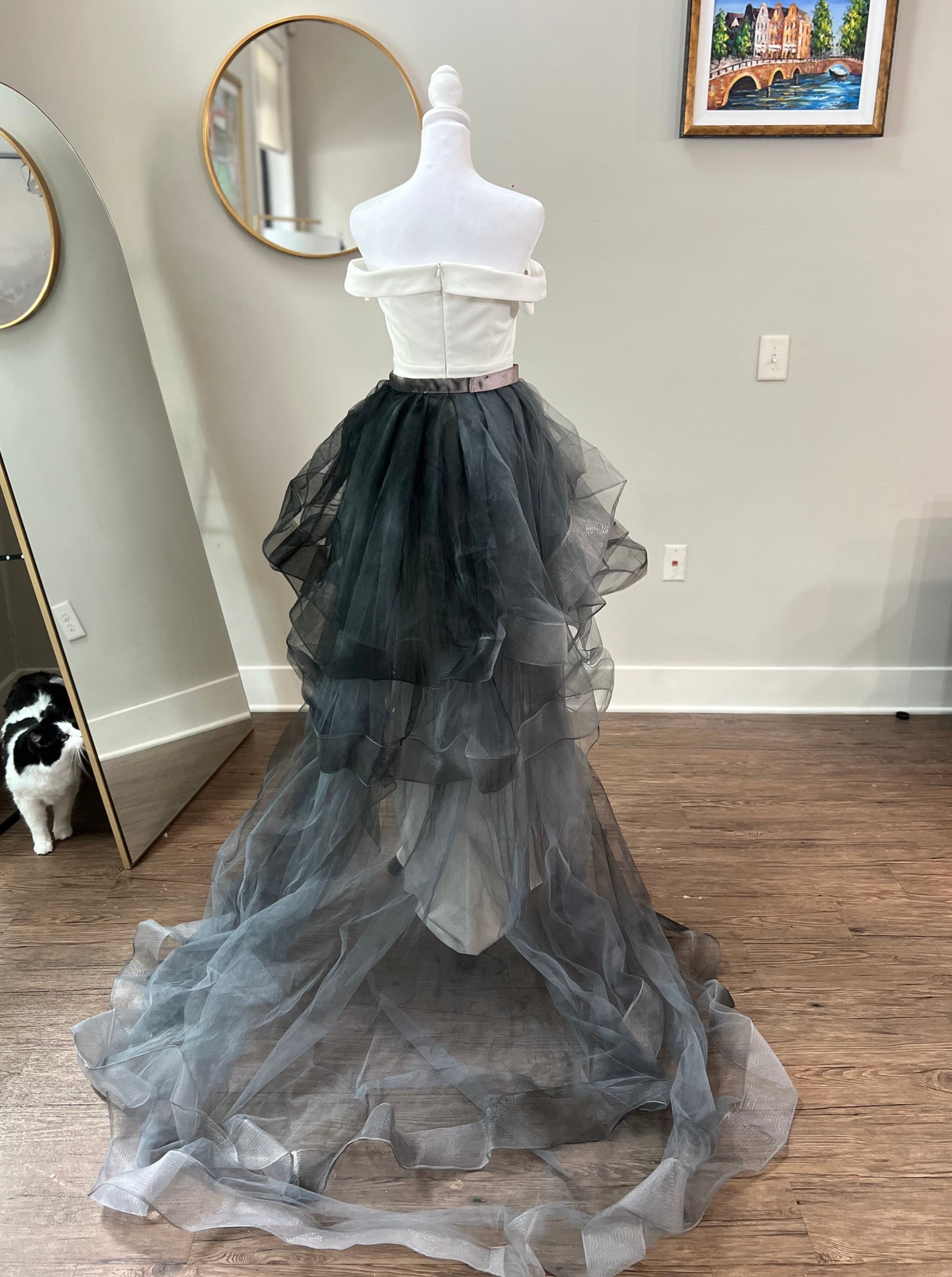 Stunning black wedding dress with a long, flowing train adorned with delicate lace details, perfect for an elegant and dramatic bridal entrance at a gothic-themed wedding.