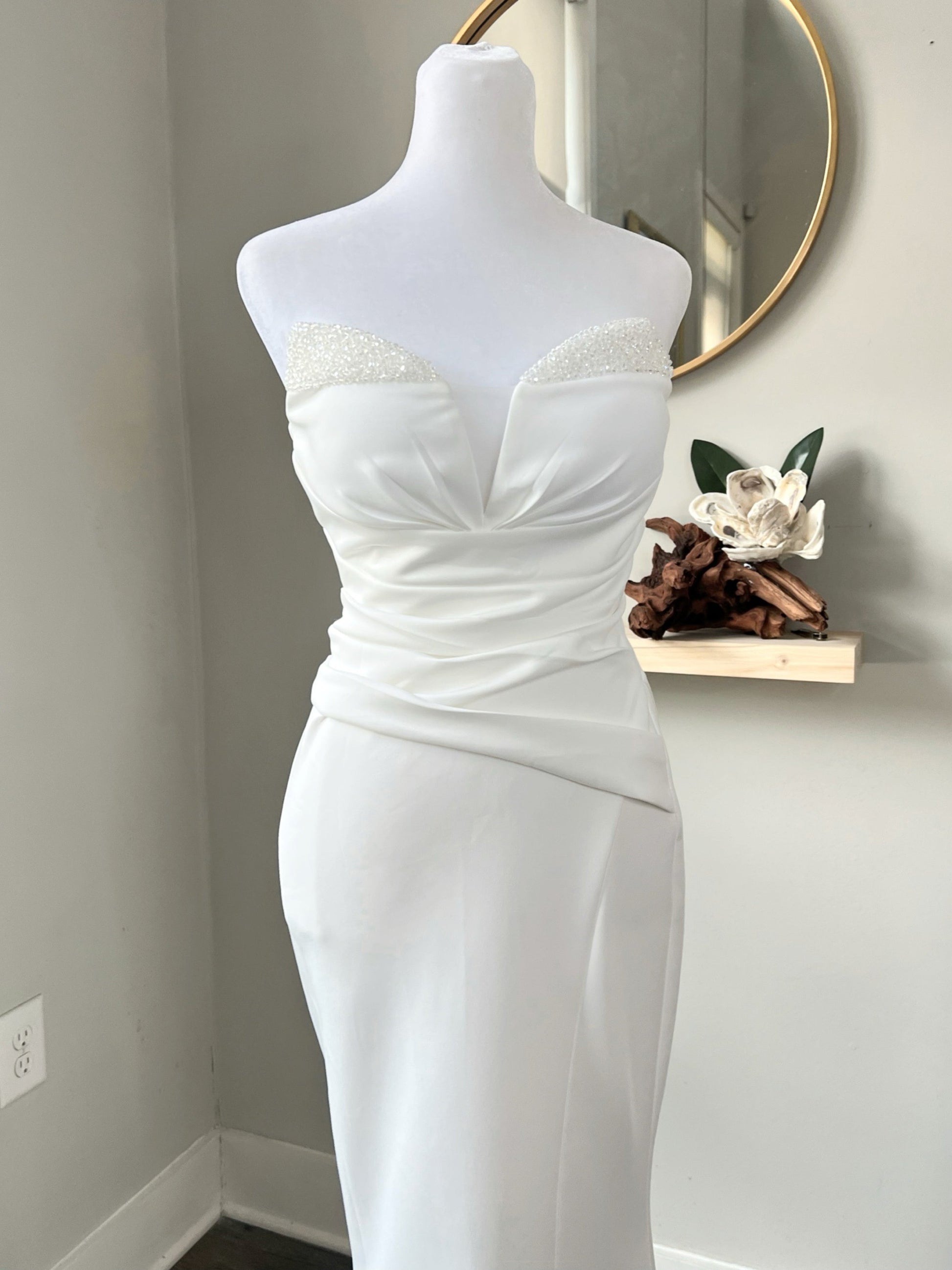 A stretchy wedding dress on mannequin with sequin trim sweetheart neckline