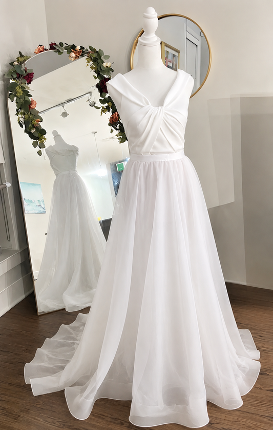 Shop a detachable organza wedding skirt with flowing train. A sheer bridal overskirt overlay designed to transform your gown for a romantic ceremony look.